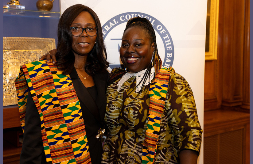 A photo of two people smiling at the camera