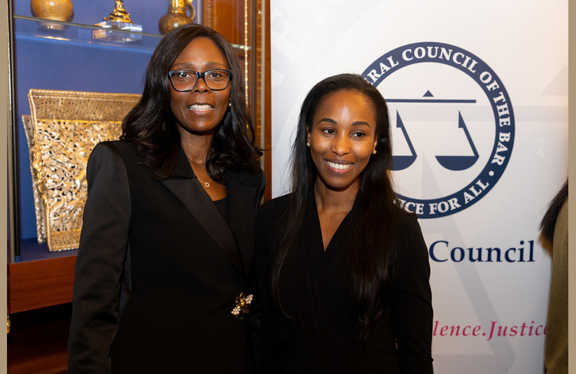 A photo of two people smiling at the camera