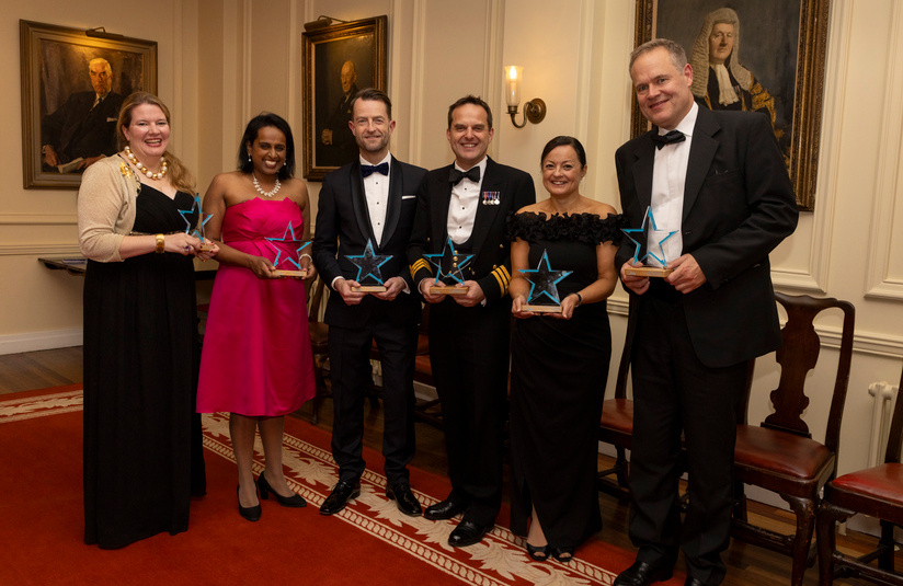 A photo of all the award winners standing and holding their awards