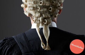 Barrister's back wearing a wig and a gown with 
