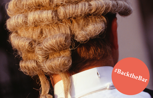 The back of a barrister's head with a graphic of text: #BacktheBar