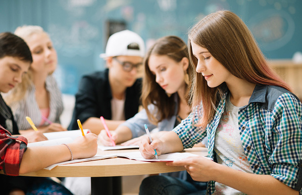 Group of students studying on a table.