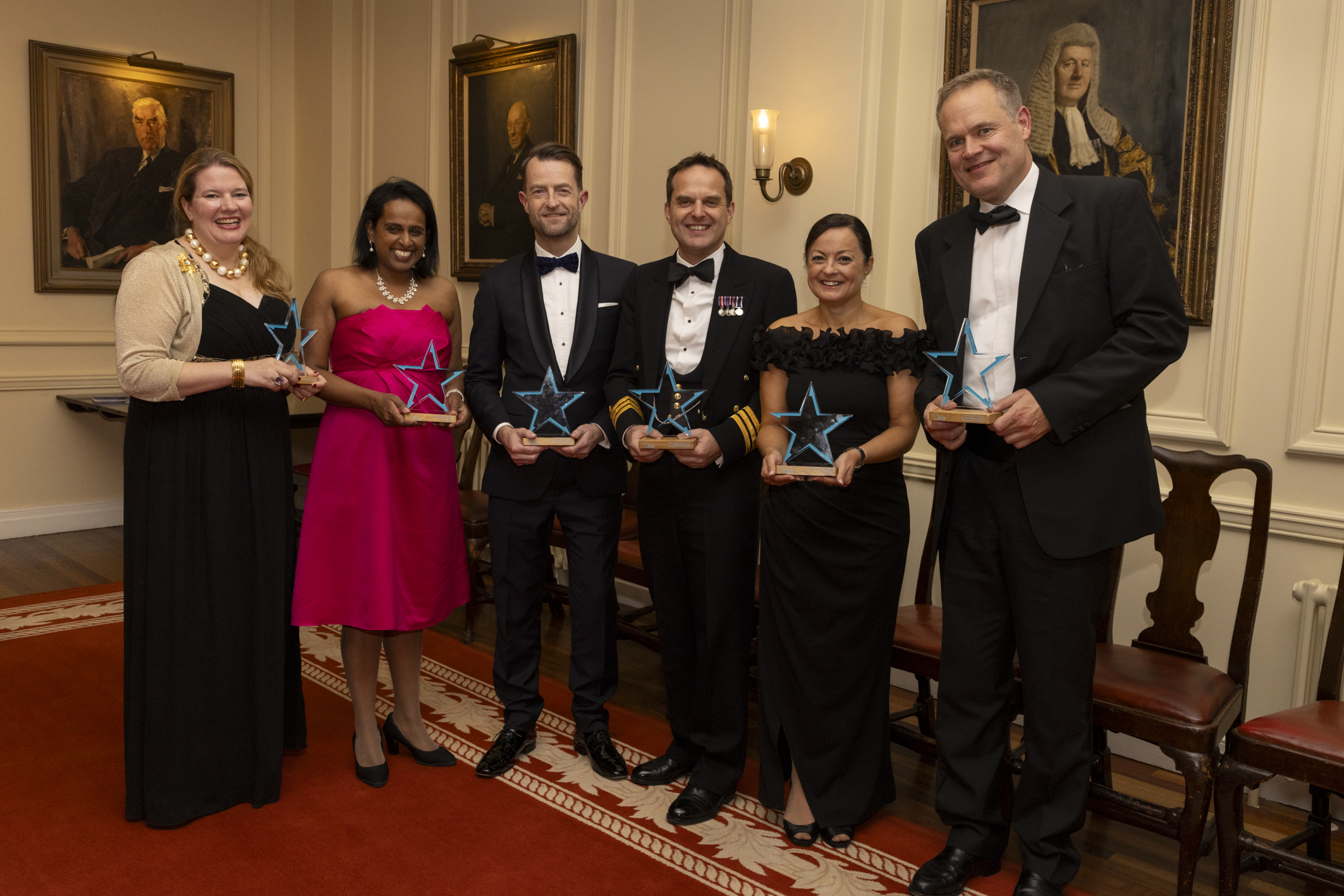 Photo of the winners: Lucinda Orr, Sira Abraham, Chris Loweth, Cdr Mark Blackwell, Fiona Butler, and Daniel Lee on behalf of GLD Winsor Fwork Team