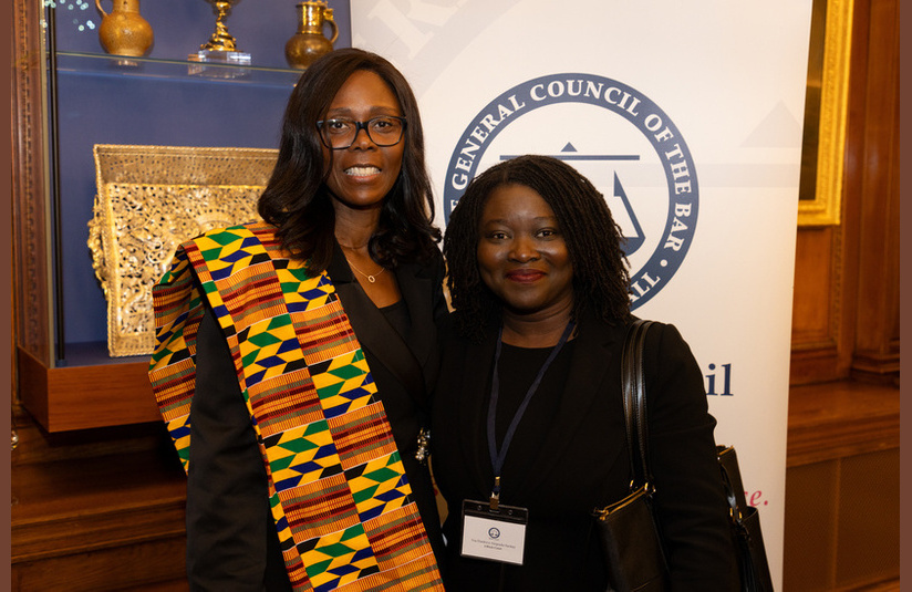 A photo of two people smiling at the camera