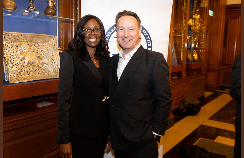 A photo of two people smiling at the camera