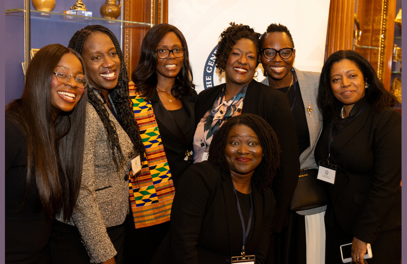 A photo of a group of people smiling at the camera