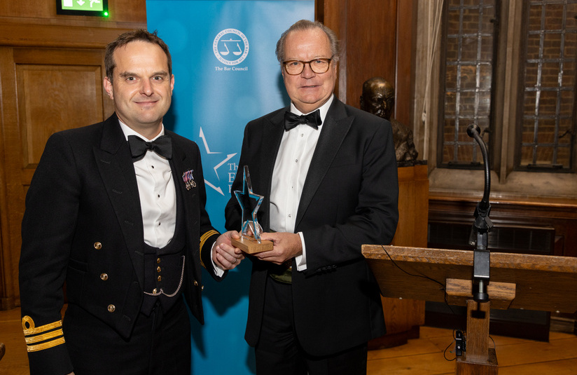 A photo of Cdr Mark Blackwell with his award