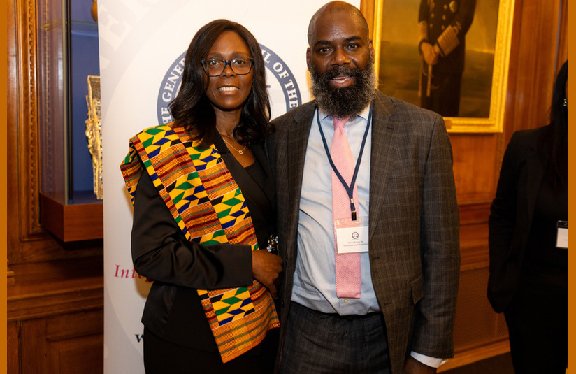 A photo of Barbara Mills KC and Simon Regis looking at the camera