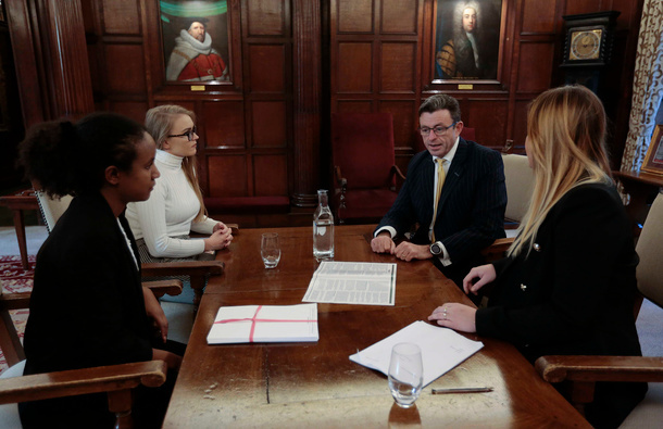 Group of barristers working around a table.