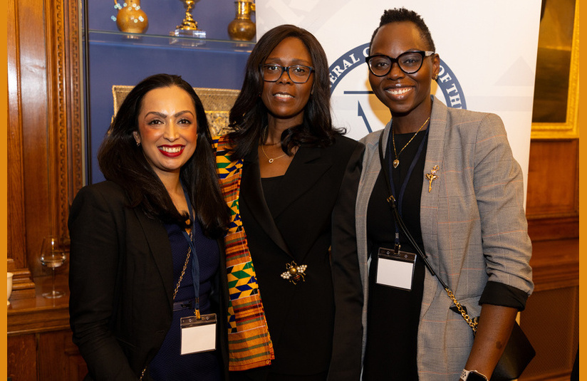 A photo of three people smiling at the camera