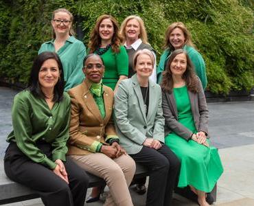 A photo of a group of people all wearing green