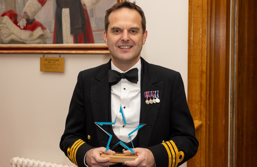 A photo of Cdr Mark Blackwell with his award