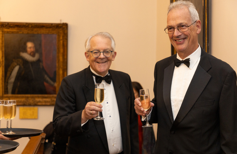 A photo of two people standing and holding champagne