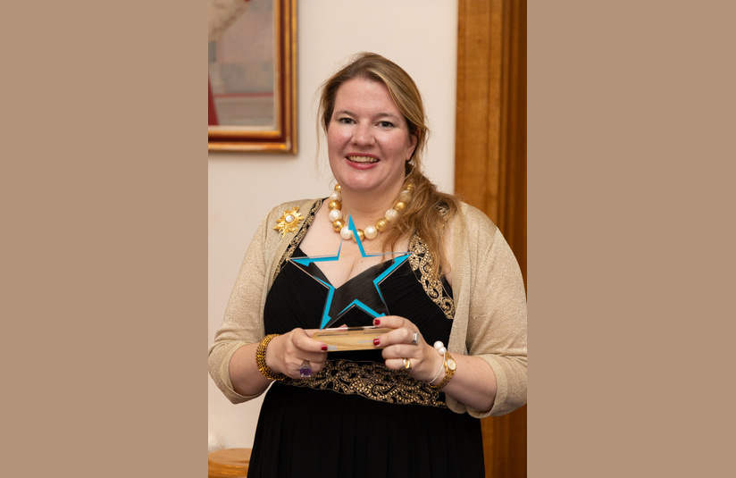 A photo of Lucinda Orr with her award