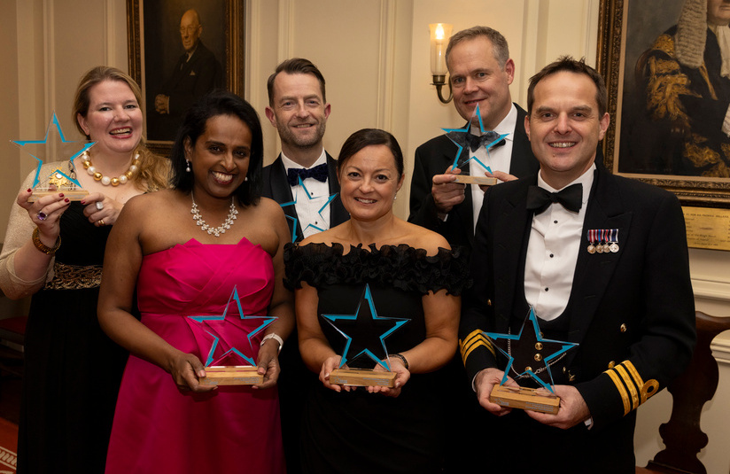 A photo of all the award winners standing and holding their awards