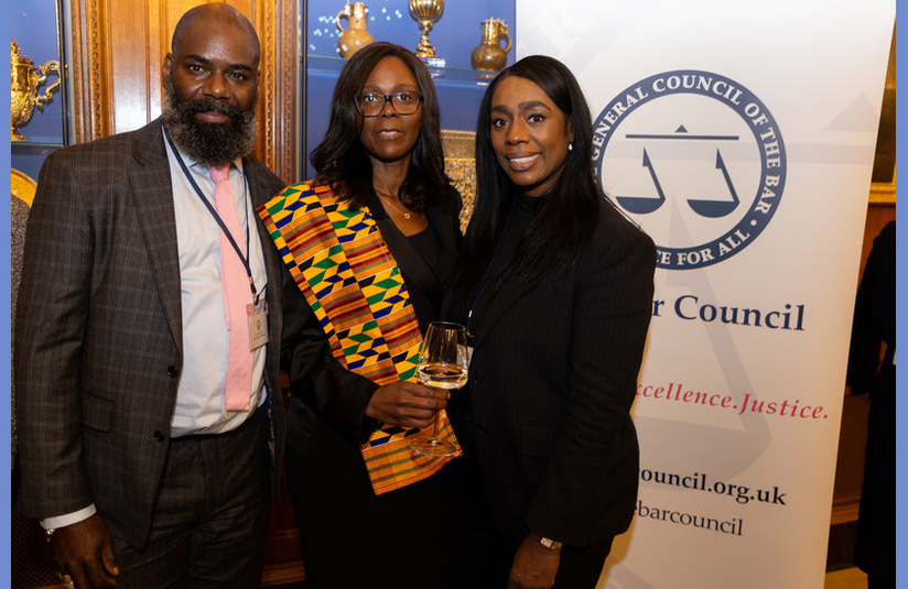 A photo of three people looking at the camera